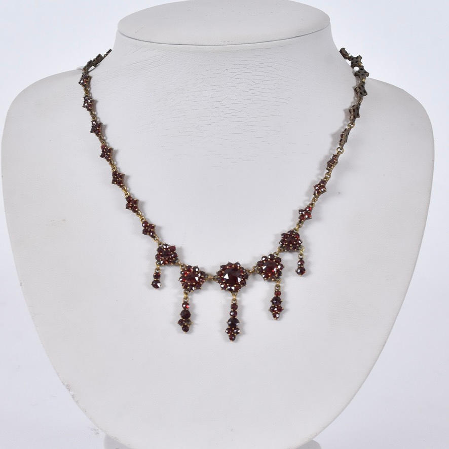NECKLACE, brass with faceted garnets.