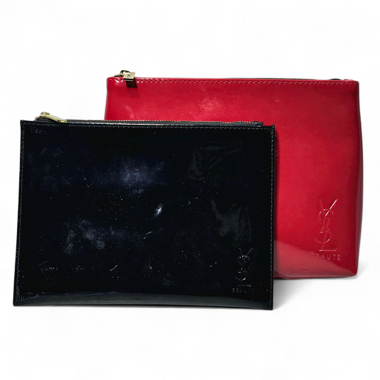 YVES SAINT LAURENT. Two vanity cases in red and black patent leather ...