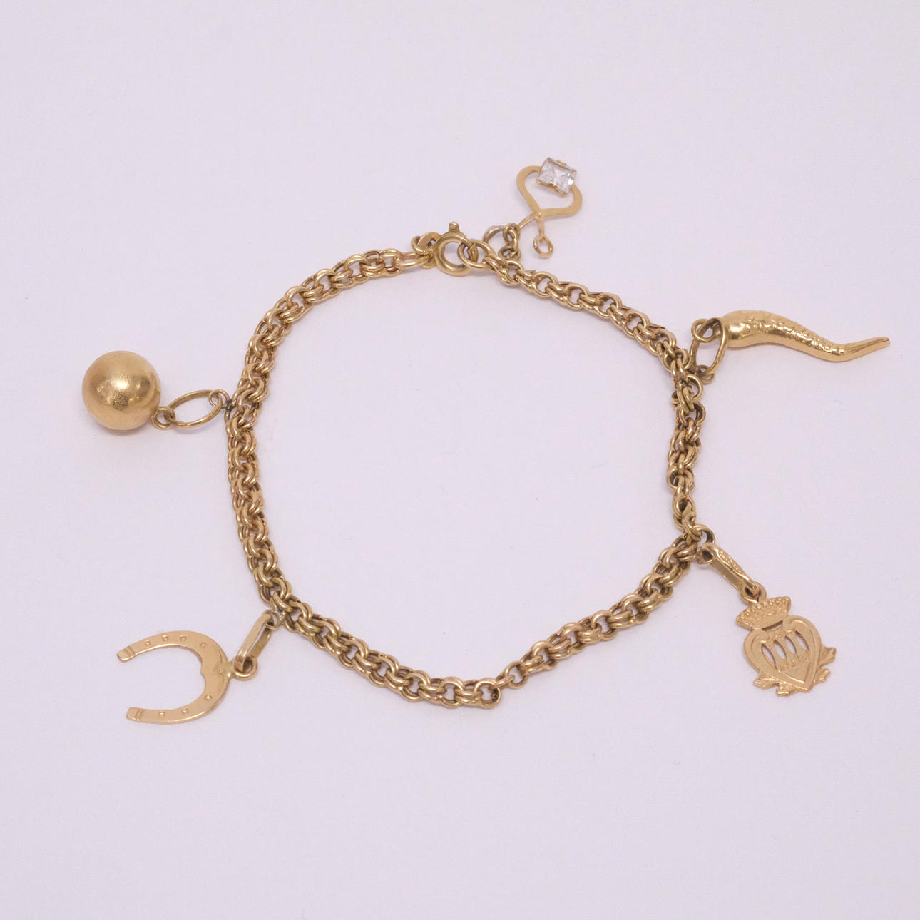 ARMBAND MED BERLOCKER, 18K GULD.