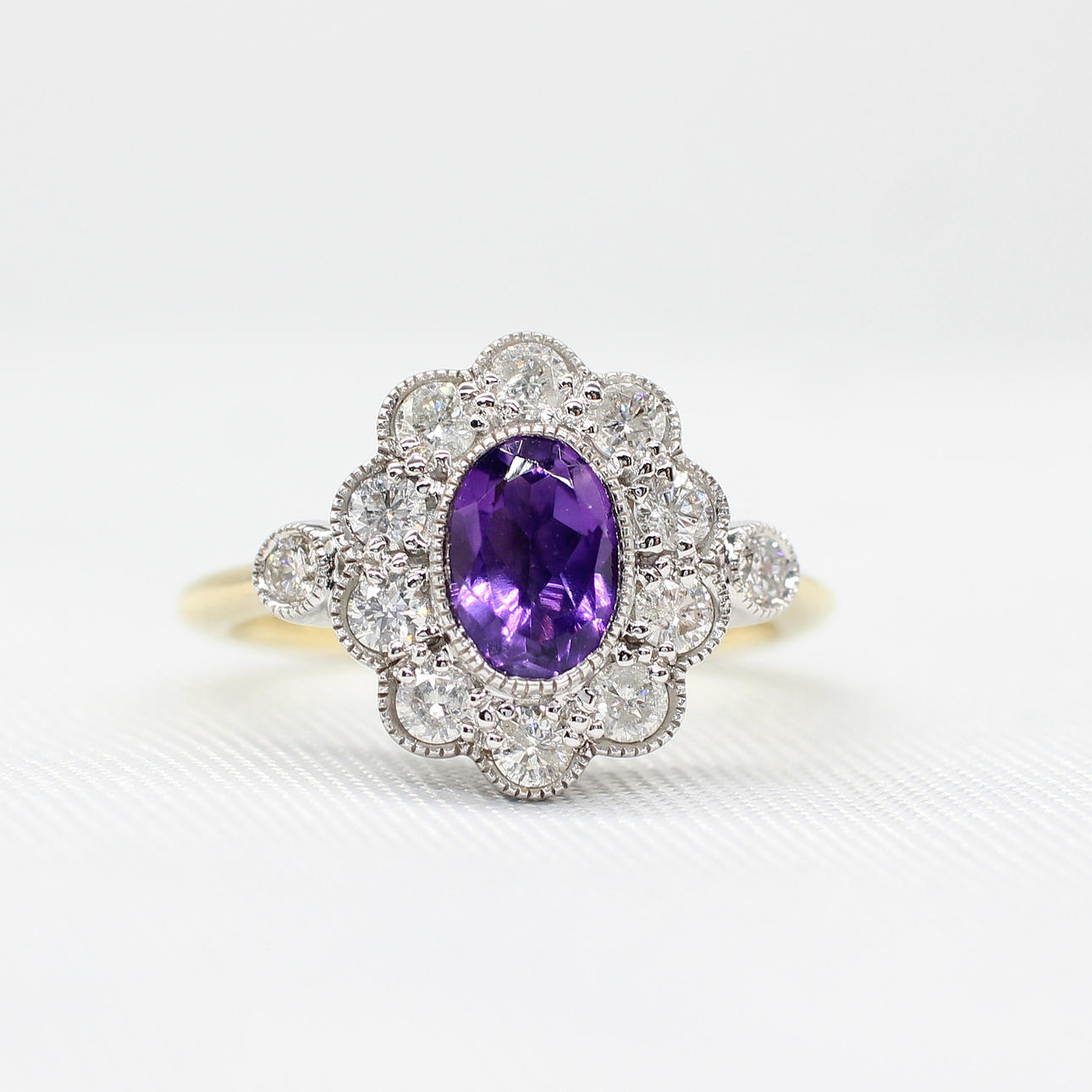 AMETHYST & DIAMOND DAISY RING.