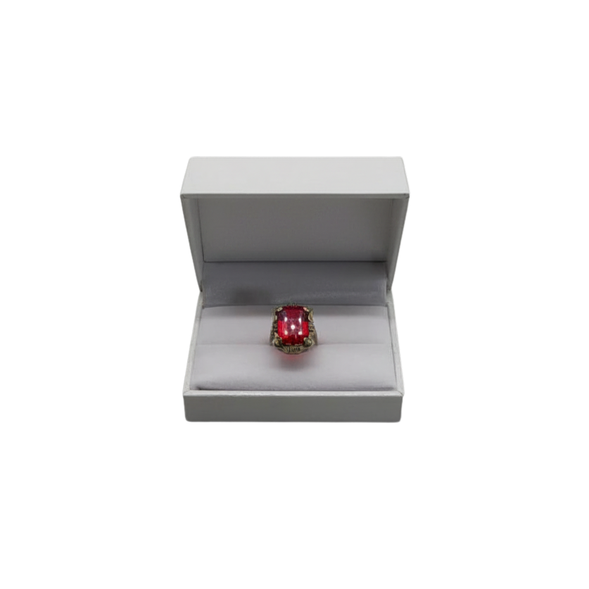 SILVER RING WITH RED COLOURED STONE.
