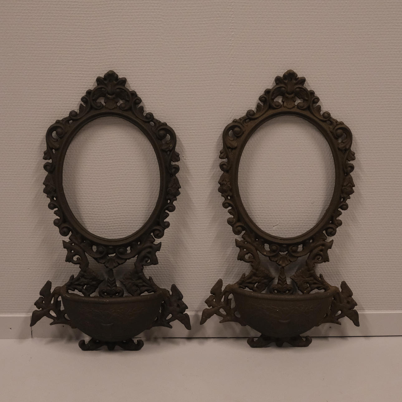 WALL MIRRORS, A PAIR, CAST IRON.