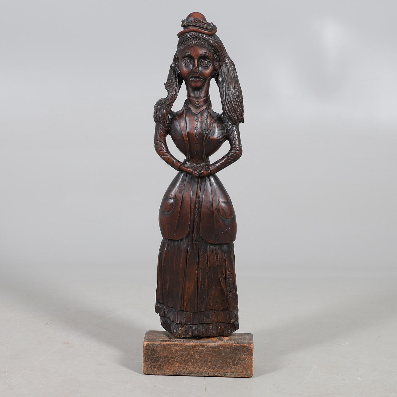 A LARGE VICTORIAN CARVED OAK (?) FIGURAL DOORSTOP.