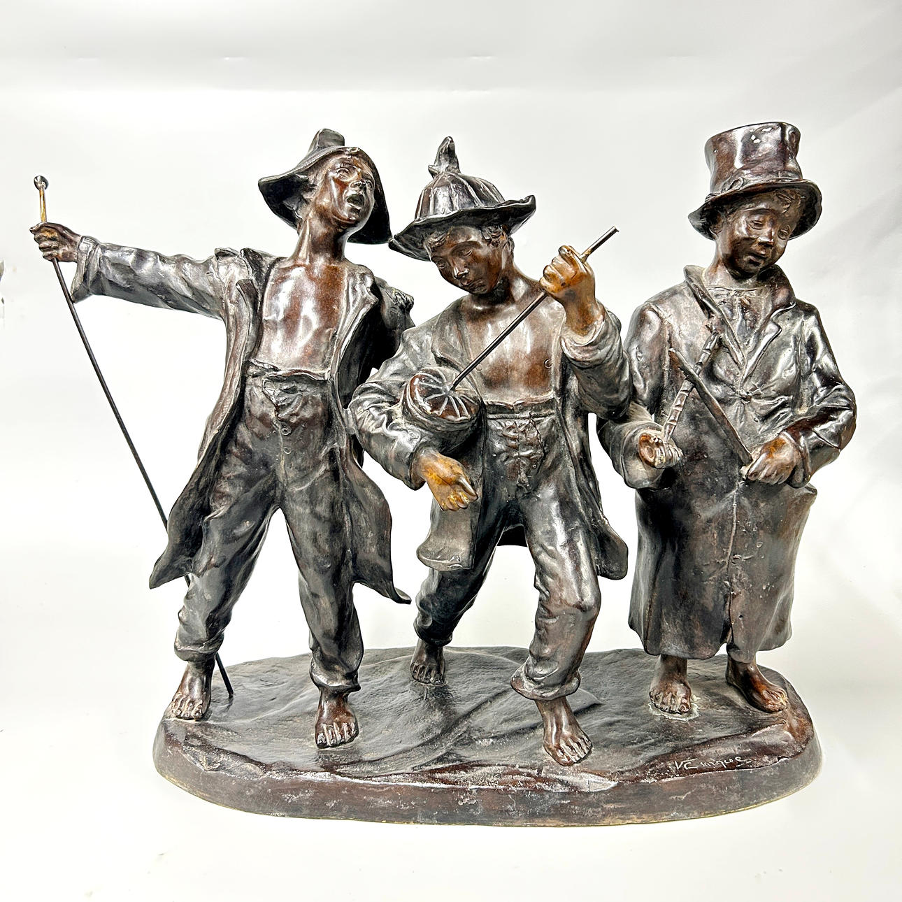 LARGE BRONZE BOYS PLAYING INSTRUMENTS.