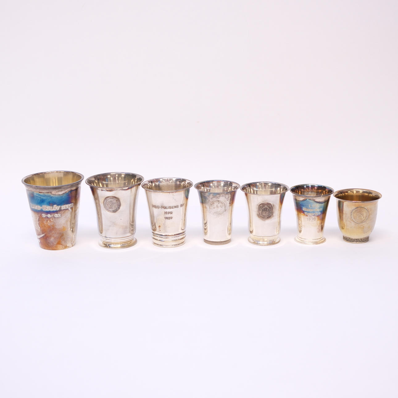 BEAKERS, SILVER, SEVEN PIECES.
