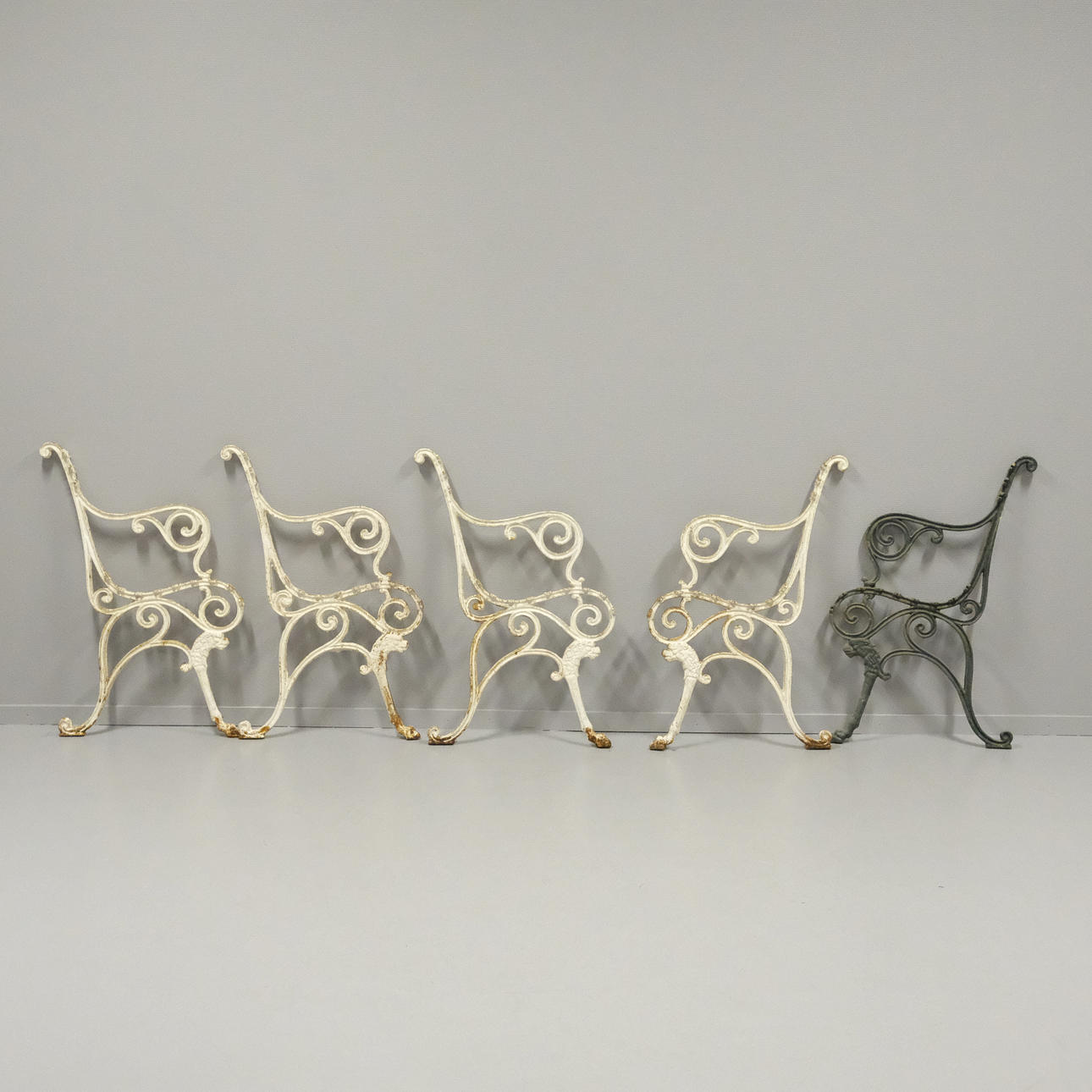 FIVE CAST IRON END PIECES, CIRCA 1900.