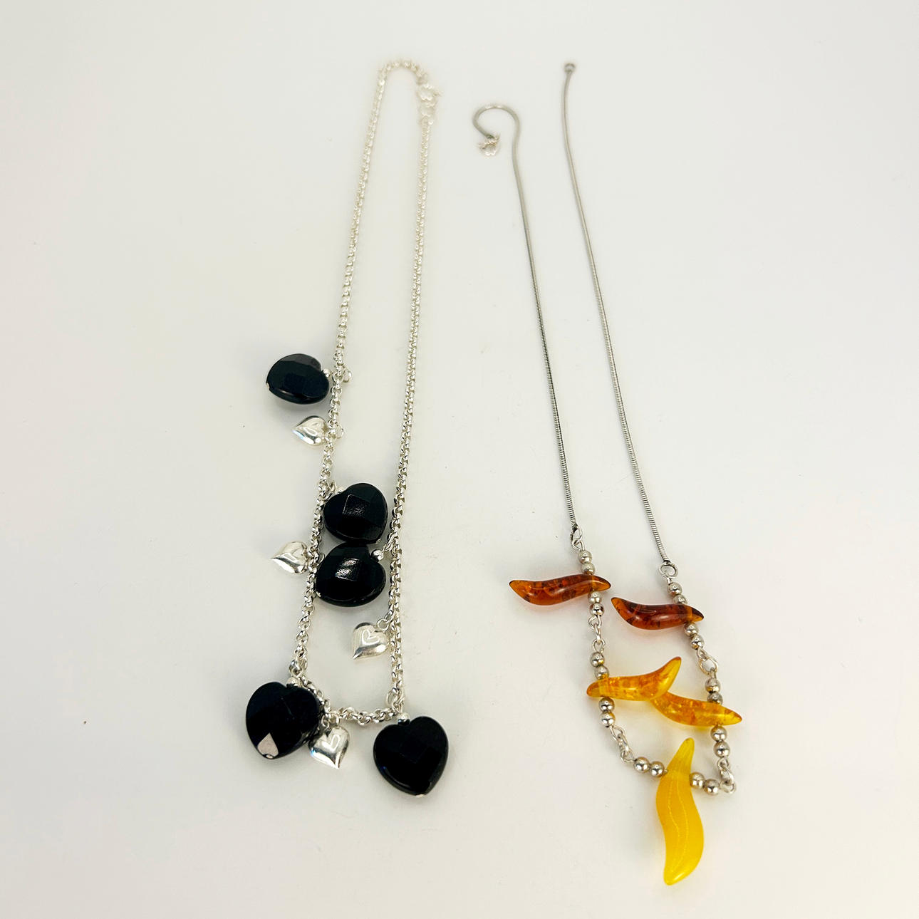 TWO SILVER STONE SET NECKLACES.