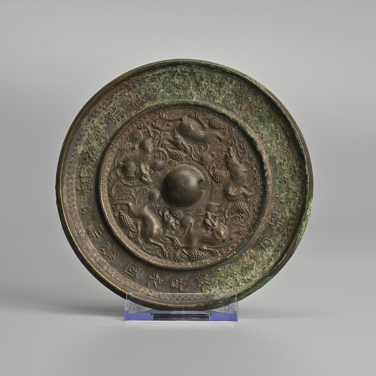 A CHINESE BRONZE 'BEASTS AND GRAPEVINE' MIRROR WITH POEM INSCRIPTION ...