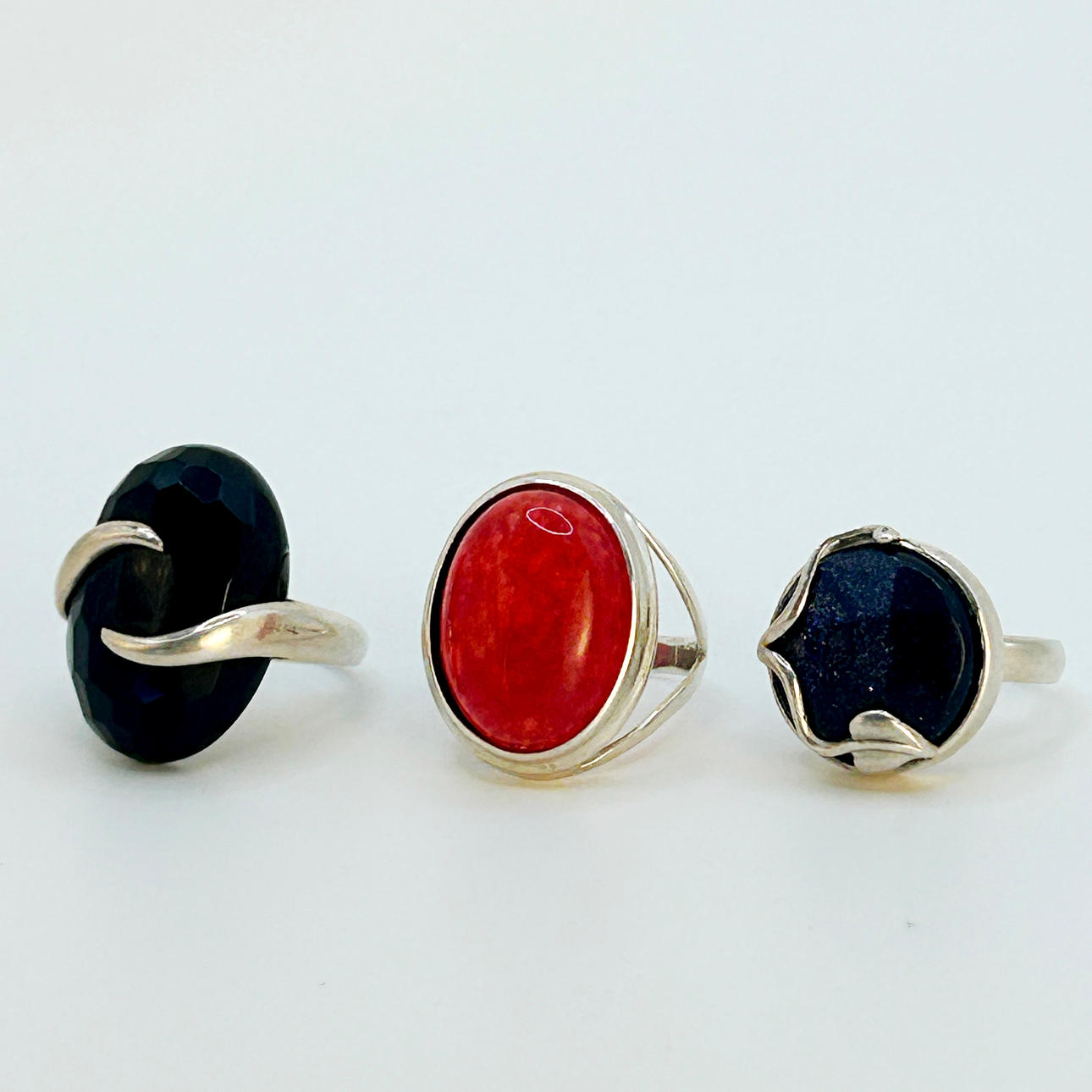 THREE SILVER STONE SET RINGS.