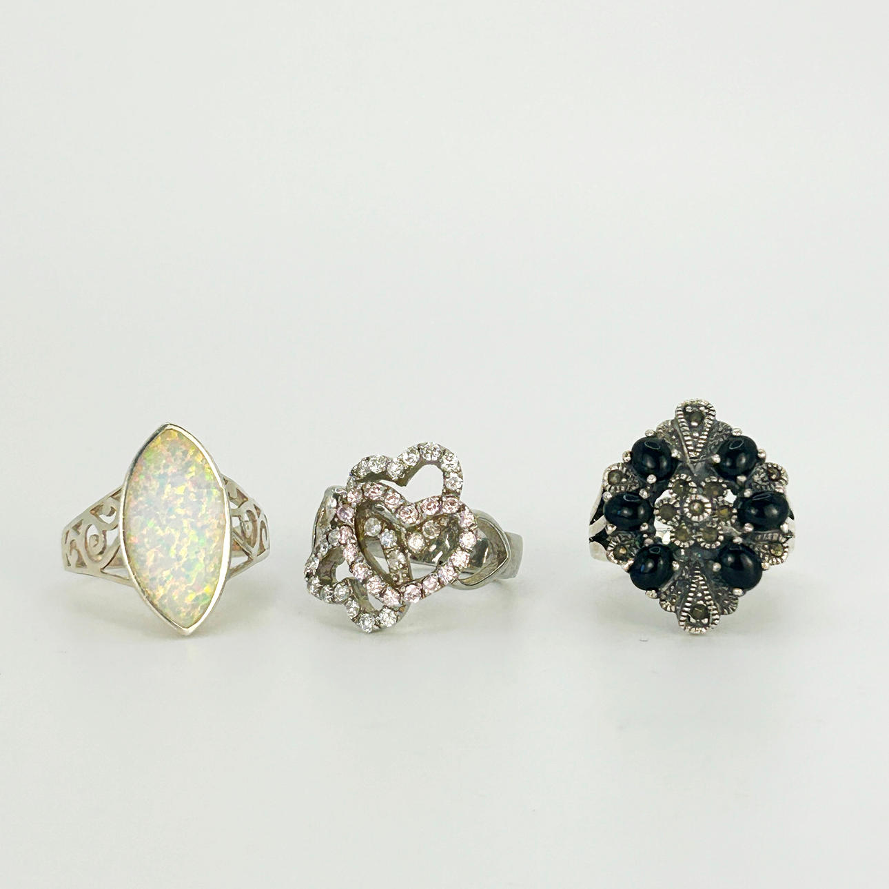 THREE SILVER STONE SET RINGS.
