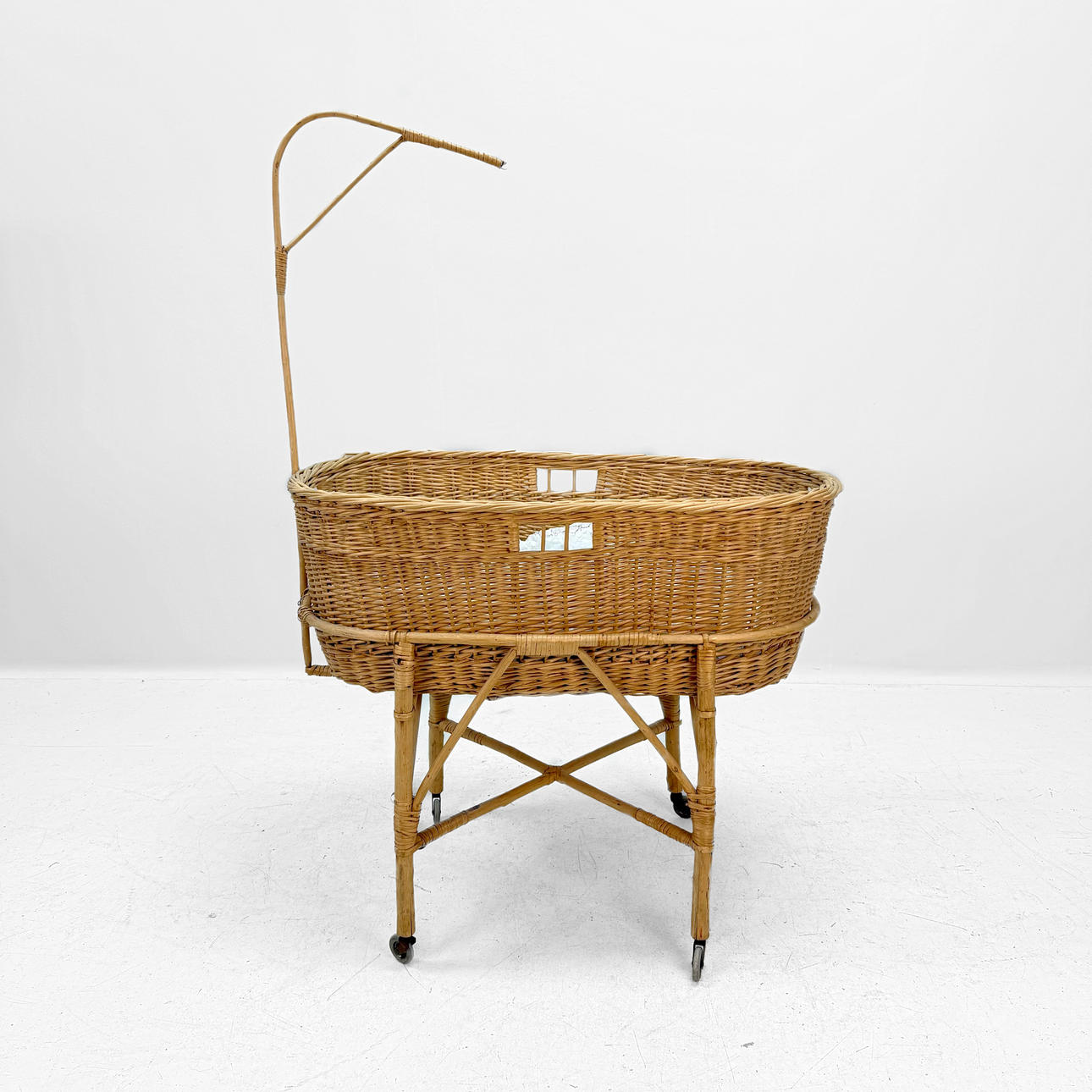 CHILD'S BED - Wicker bed with canopy on stand.