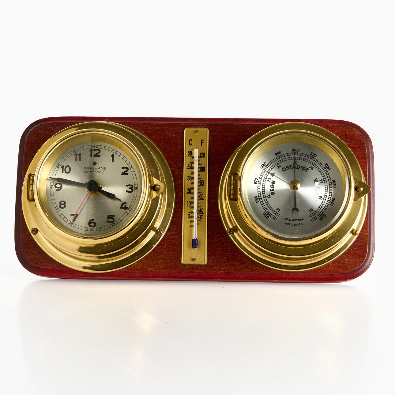 SHIP'S CLOCK, BAROMETER, THERMOMETER, mounted on a wooden base. The clock dial marked Junghans Electronic. Second half of the 20th century.