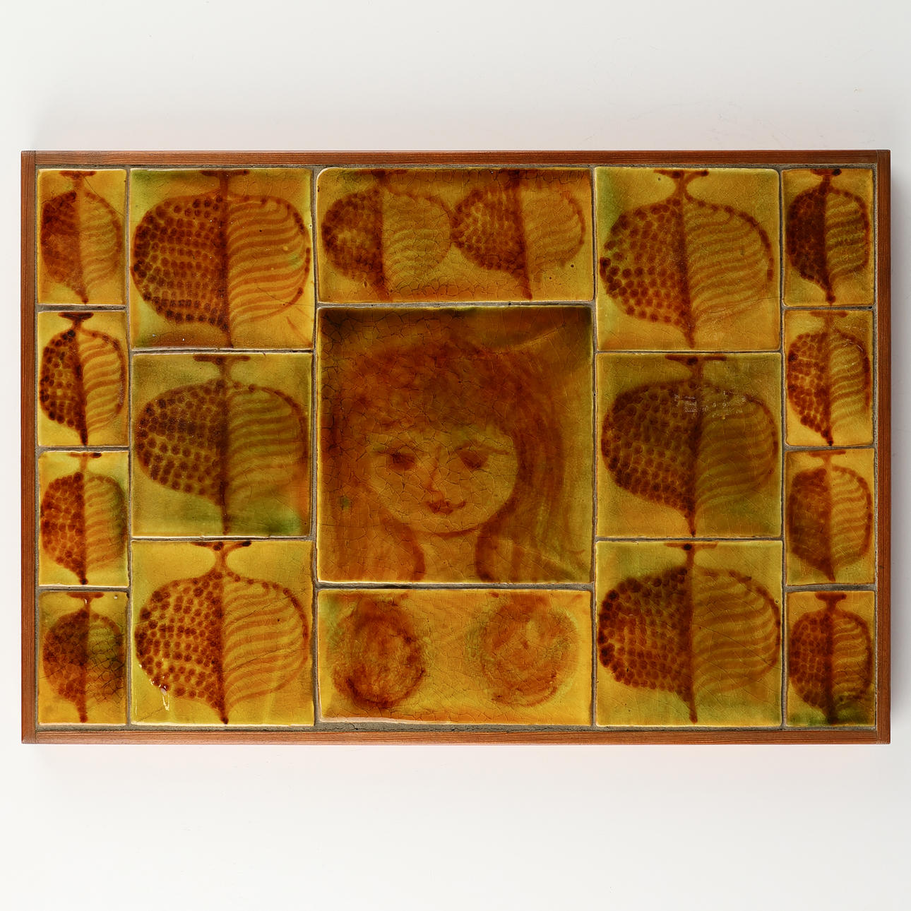 STAURBYSKOV POTTERI: Wall relief with decorated tiles and solid wood frame, Middelfart, Denmark, dated 1968.