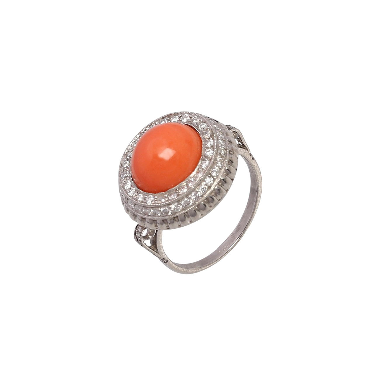 Art Deco style coral ring bordered with diamonds.