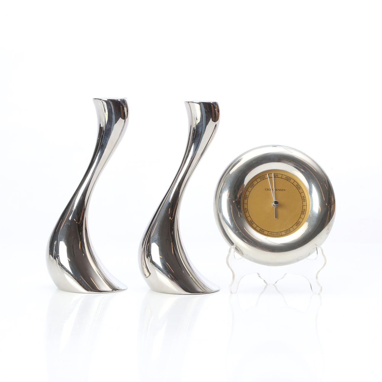 GEORG JENSEN, CANDLESTICKS, A PAIR AND BAROMETER. Contemporary production.