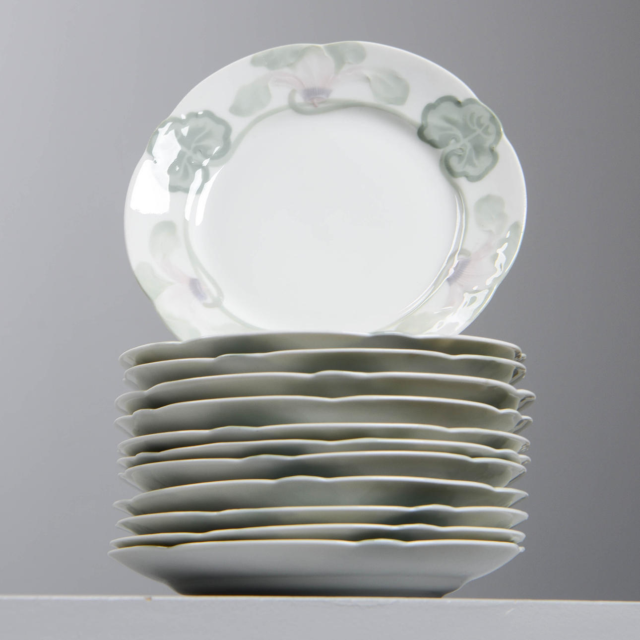 ALGOT ERIKSON. "Alpviol", 12 side plates, Rörstrand, designed 1897.