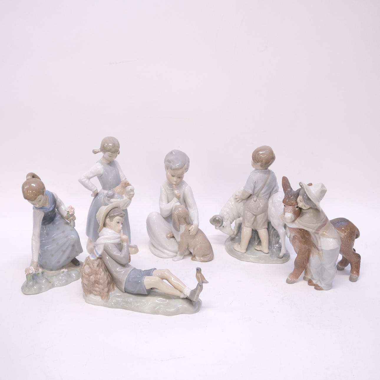 SIX FIGURINES, LLADRO AND NAO.