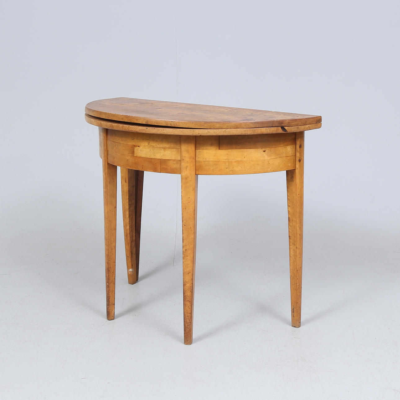 DEMILUNE TABLE, birch veneer, first half/mid-19th century.