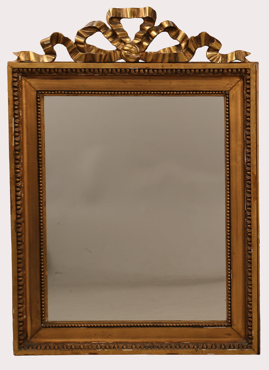 MIRROR, wood and composition, Neoclassical form with cresting rosette. First quarter of the 20th century.