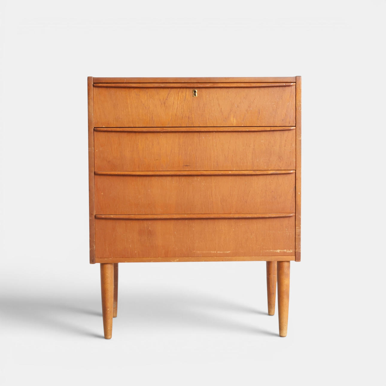 Teak chest of drawers, front with four drawers, round tapered legs ...