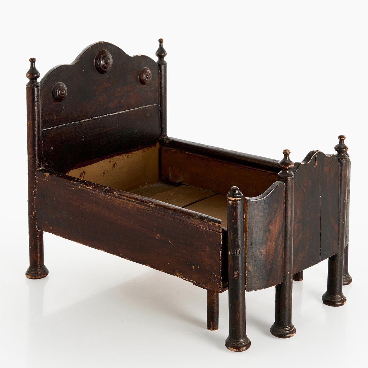 DOLL'S BED, circa 1900, stained wood.