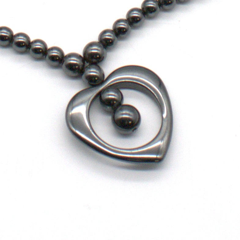 HEMATITE BEAD NECKLACE WITH HEART MOTIF.