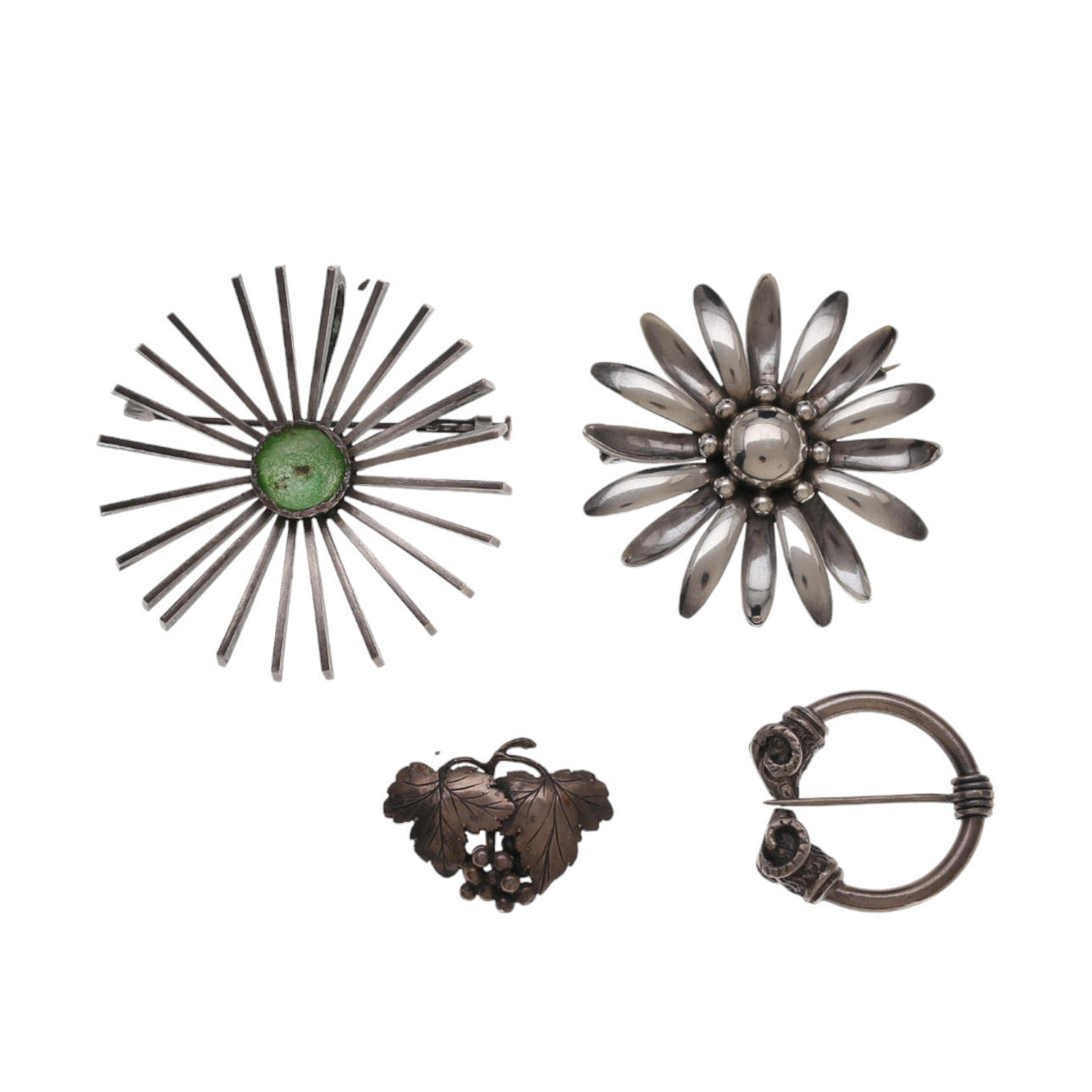 Four silver brooches.