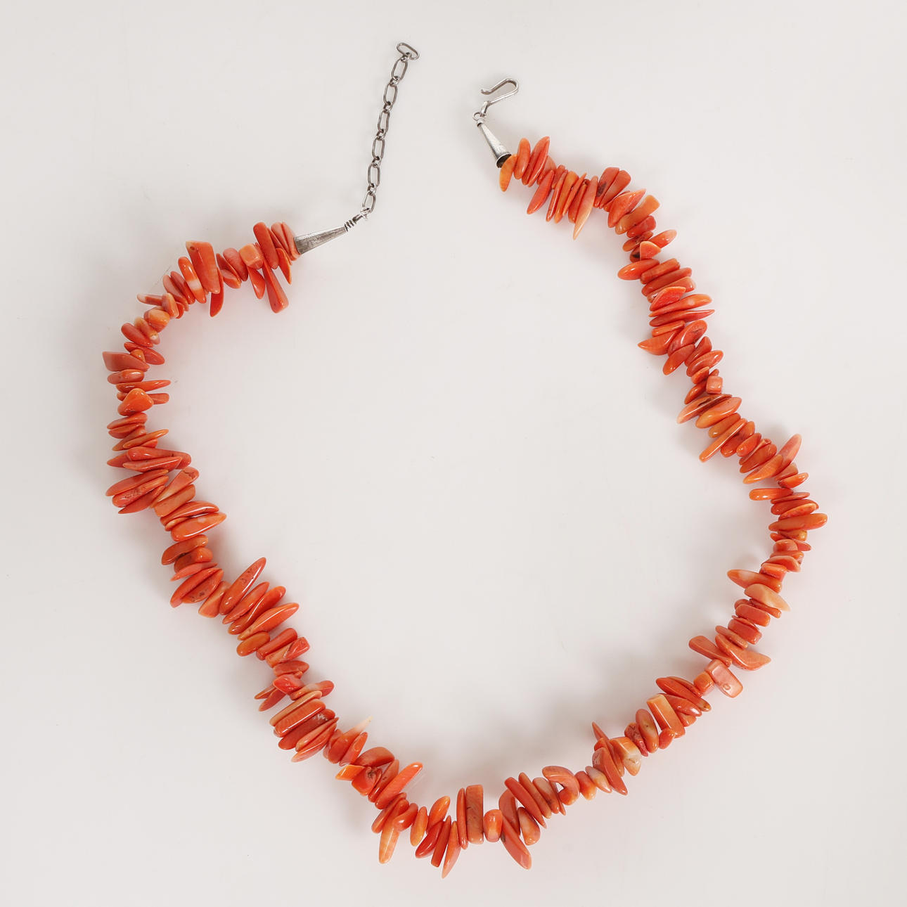 A RED CORAL & SILVER NECKLACE.