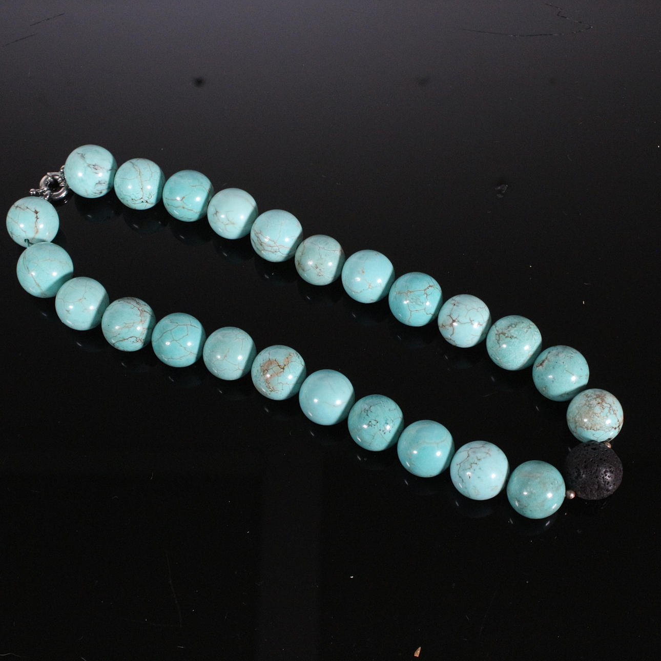 Necklace with turquoise and lava beads.