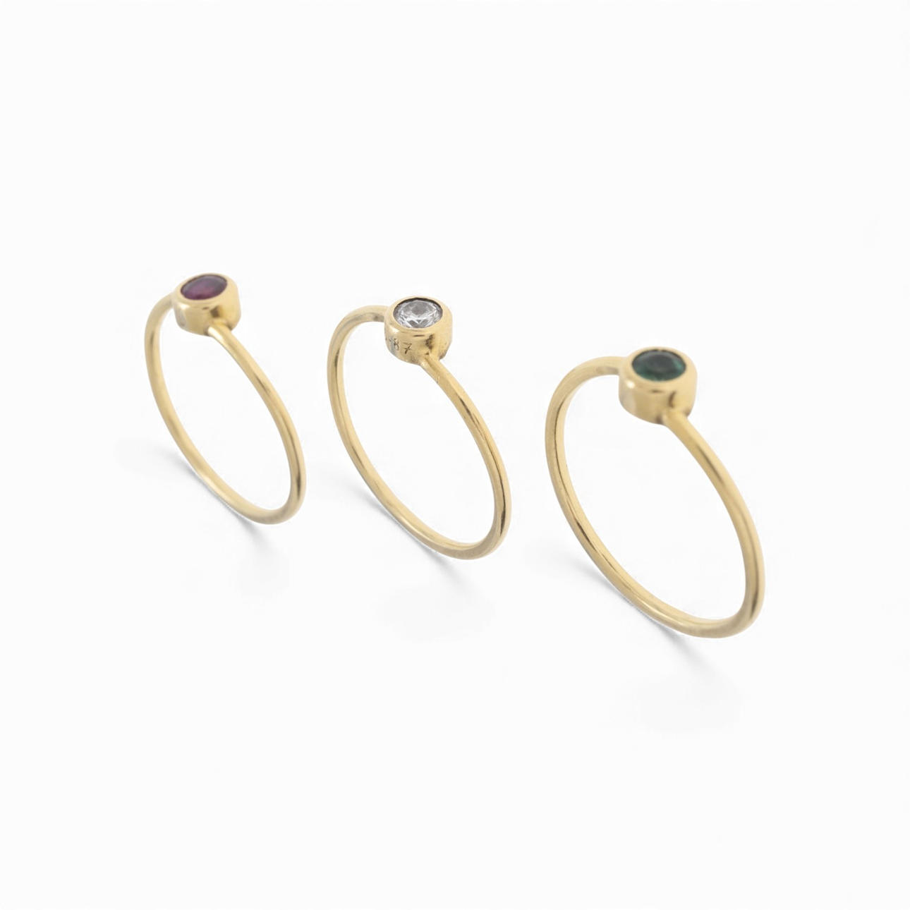 Three rings with diamond, emerald and ruby.