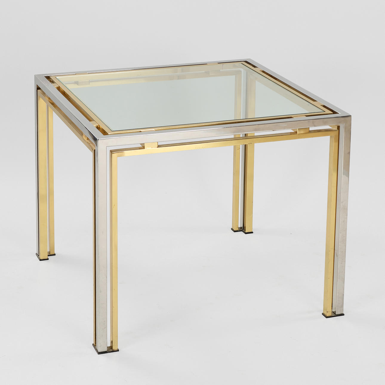 MAISON CHARLES. ATTRIBUTED. Coffee table with chrome and brass frame, glass top, Hollywood Regency, 1970s.
