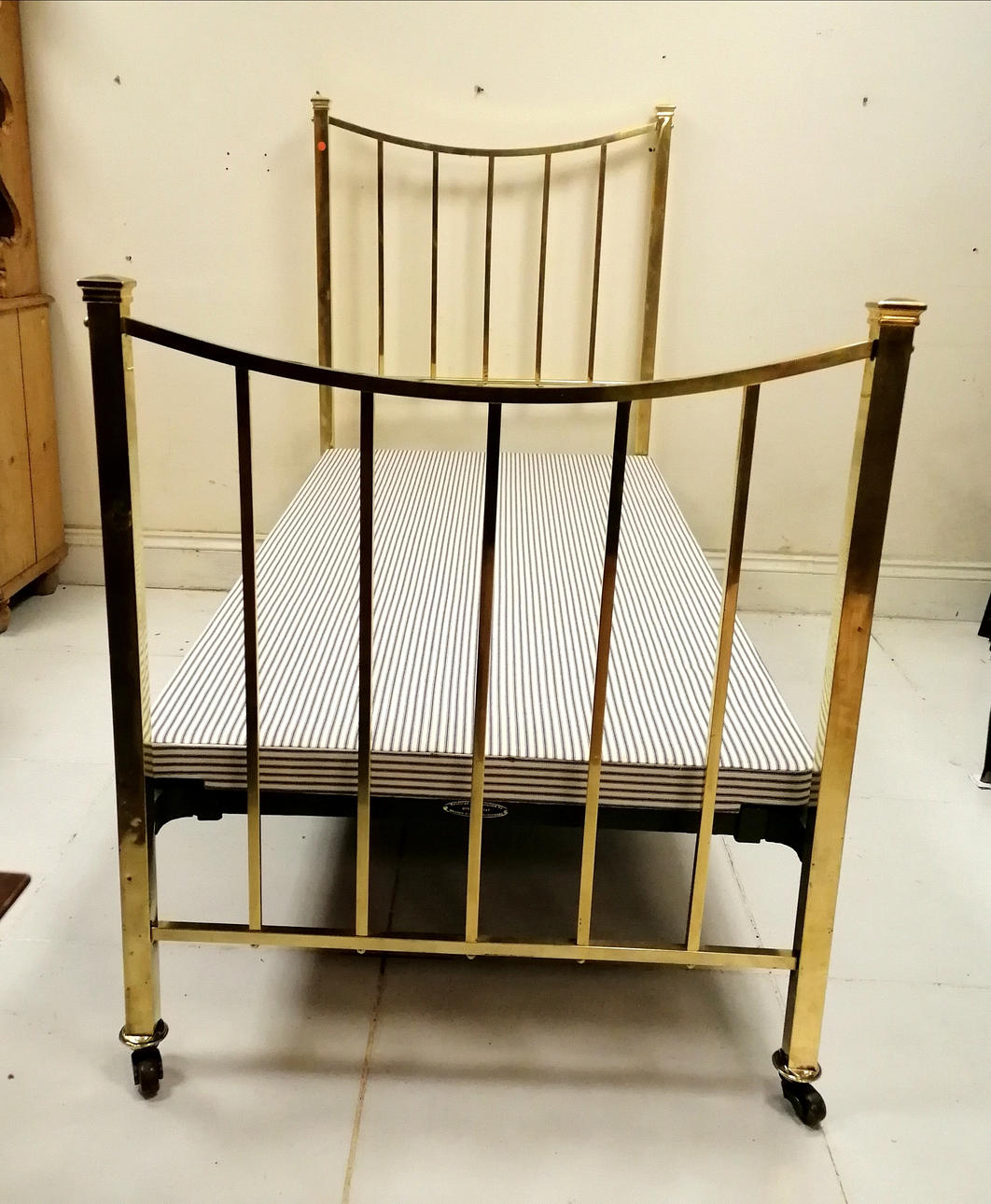 ANTIQUE SINGLE BRASS BED WITH BASE.