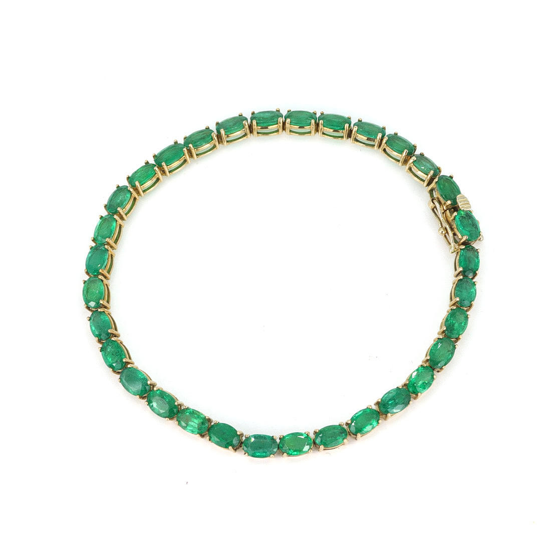 9CT GOLD EMERALD SET TENNIS BRACELET.