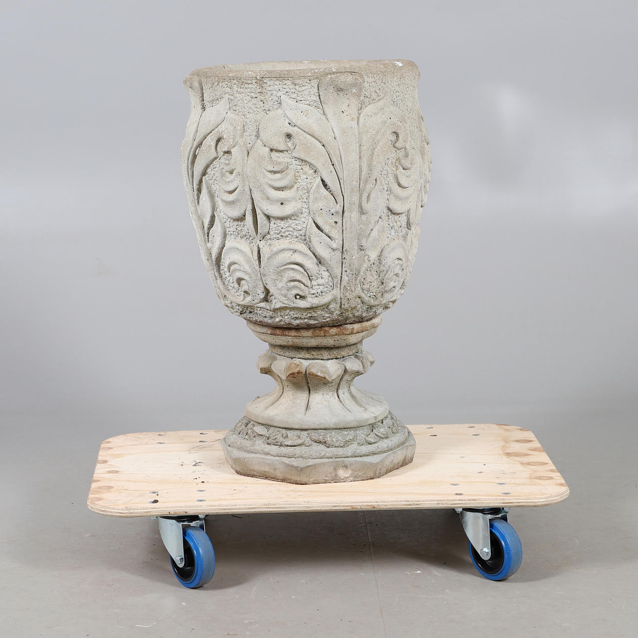 A MODERN CEMENT ACANTHUS LEAF URN.