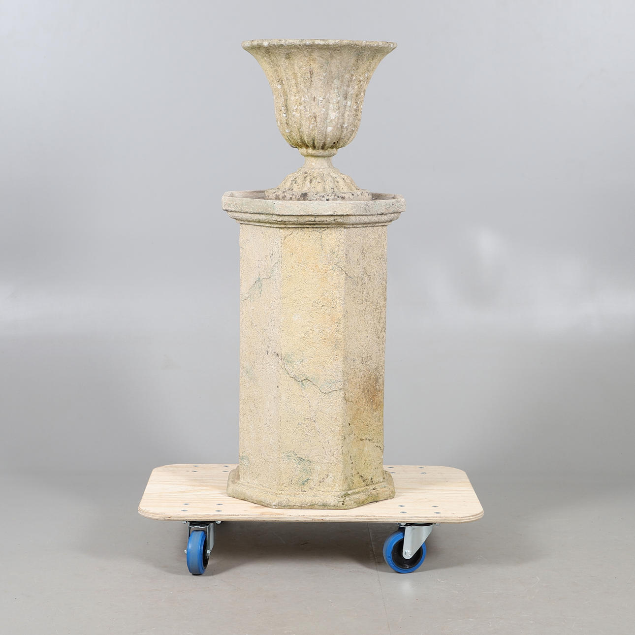 FIBREGLASS URN ON PEDESTAL BASE.