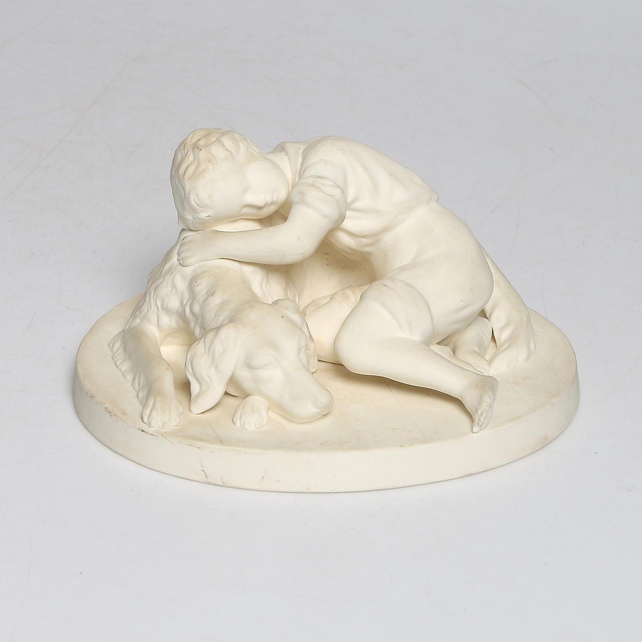 FIGURIN, parian, "Pojke med hund", A. Rudenschöld, Gustavsberg, daterad 1920.