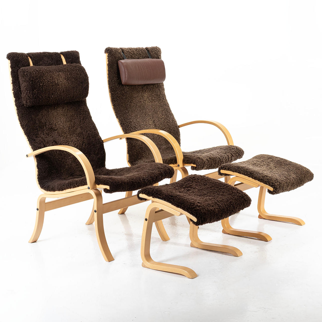 ARMCHAIRS, a pair, with footstools, contemporary, sheepskin.