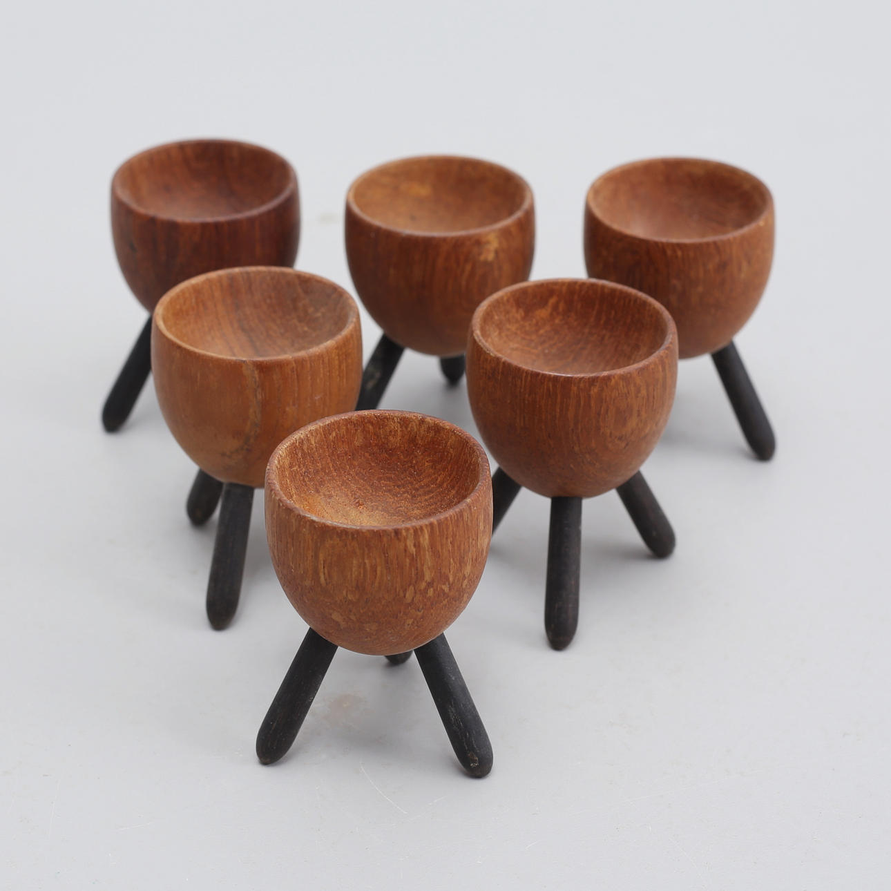 EGG CUPS, teak with tripod legs, 6 pcs, probably Denmark.