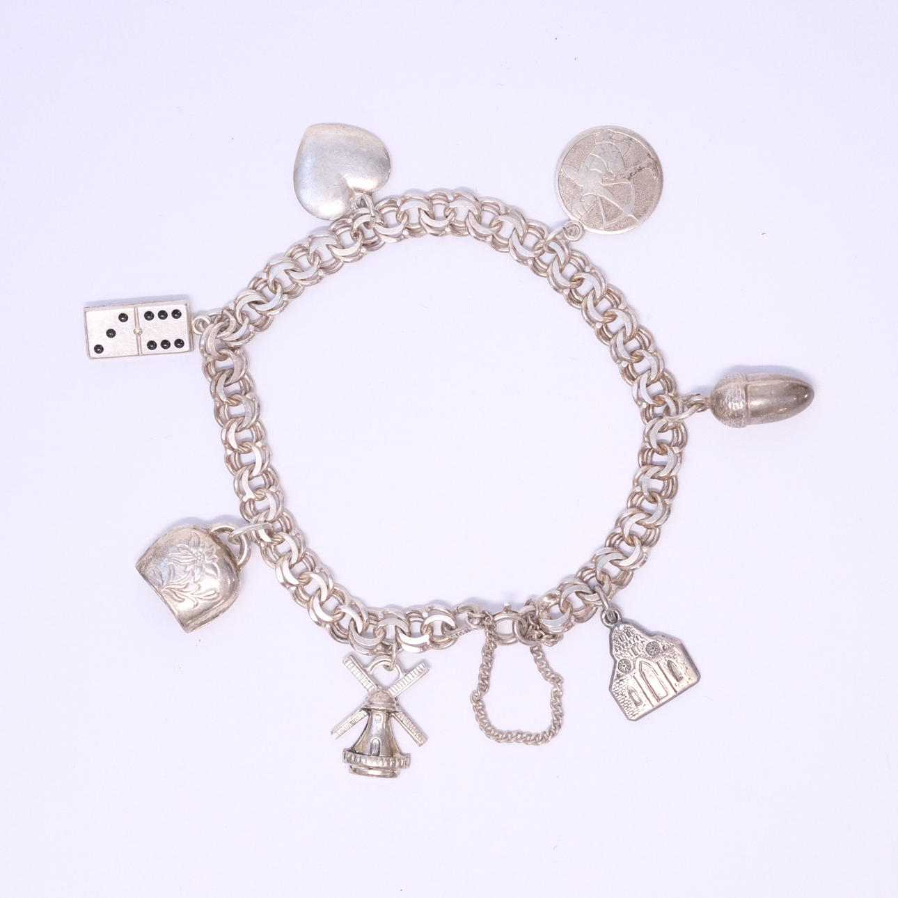BRACELET, SILVER, BISMARCK WITH CHARMS.