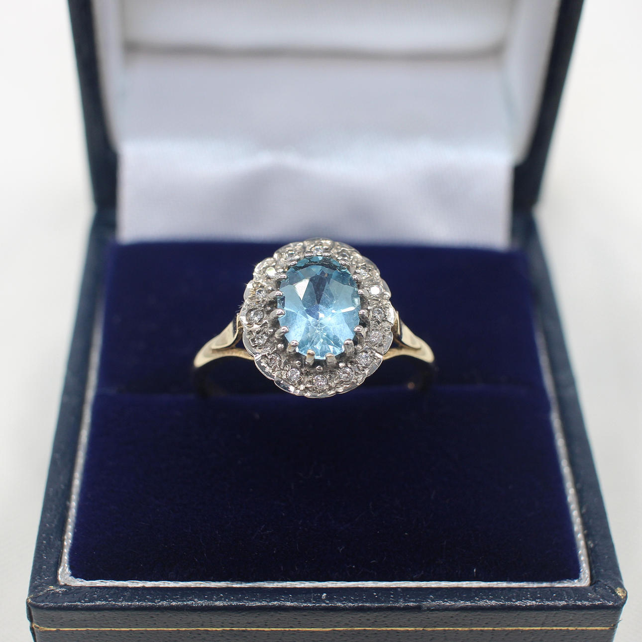 BLUE TOPAZ & DIAMOND CLUSTER RING.