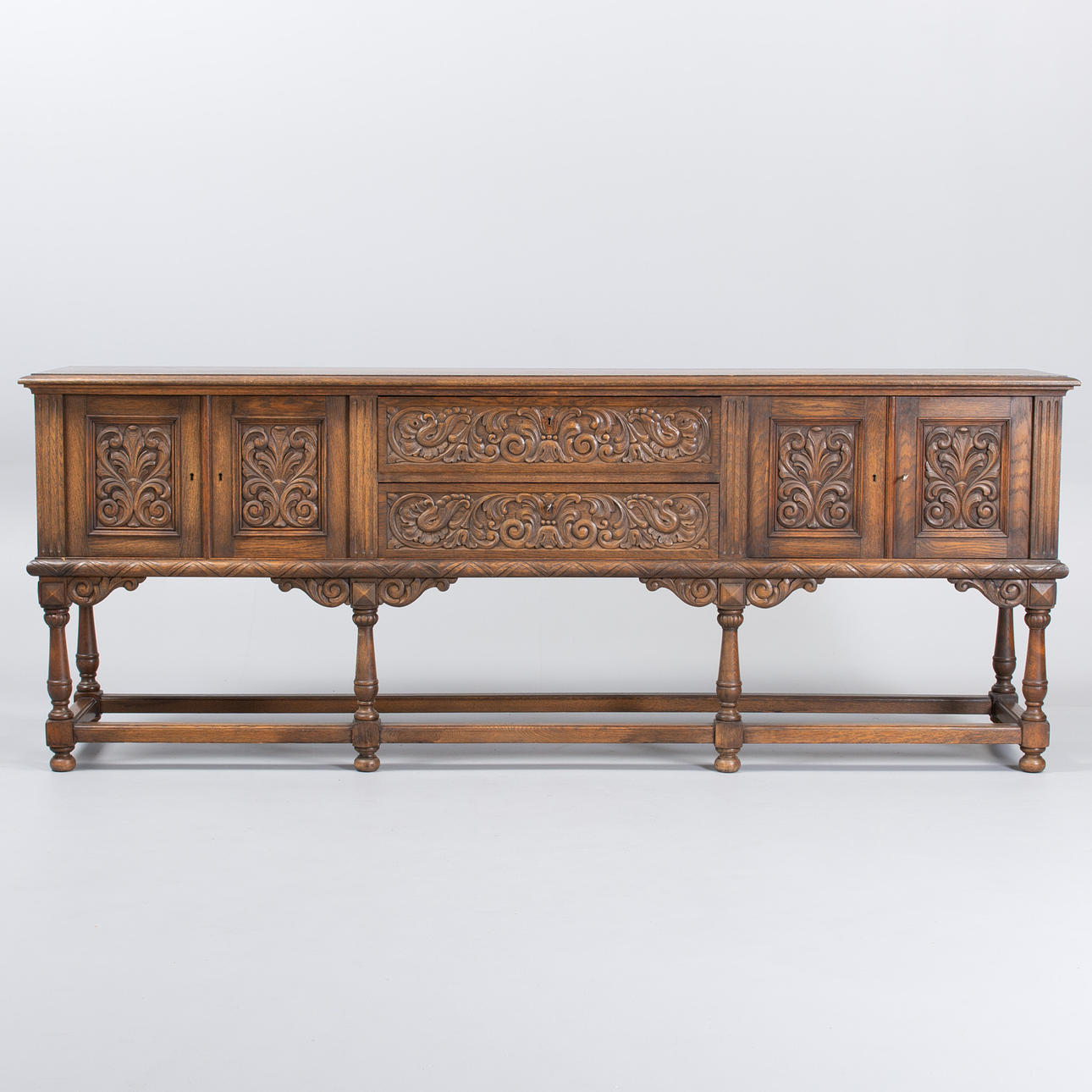 Sideboard in Baroque style, solid oak. Front with four doors and two drawers. Mid-20th century.