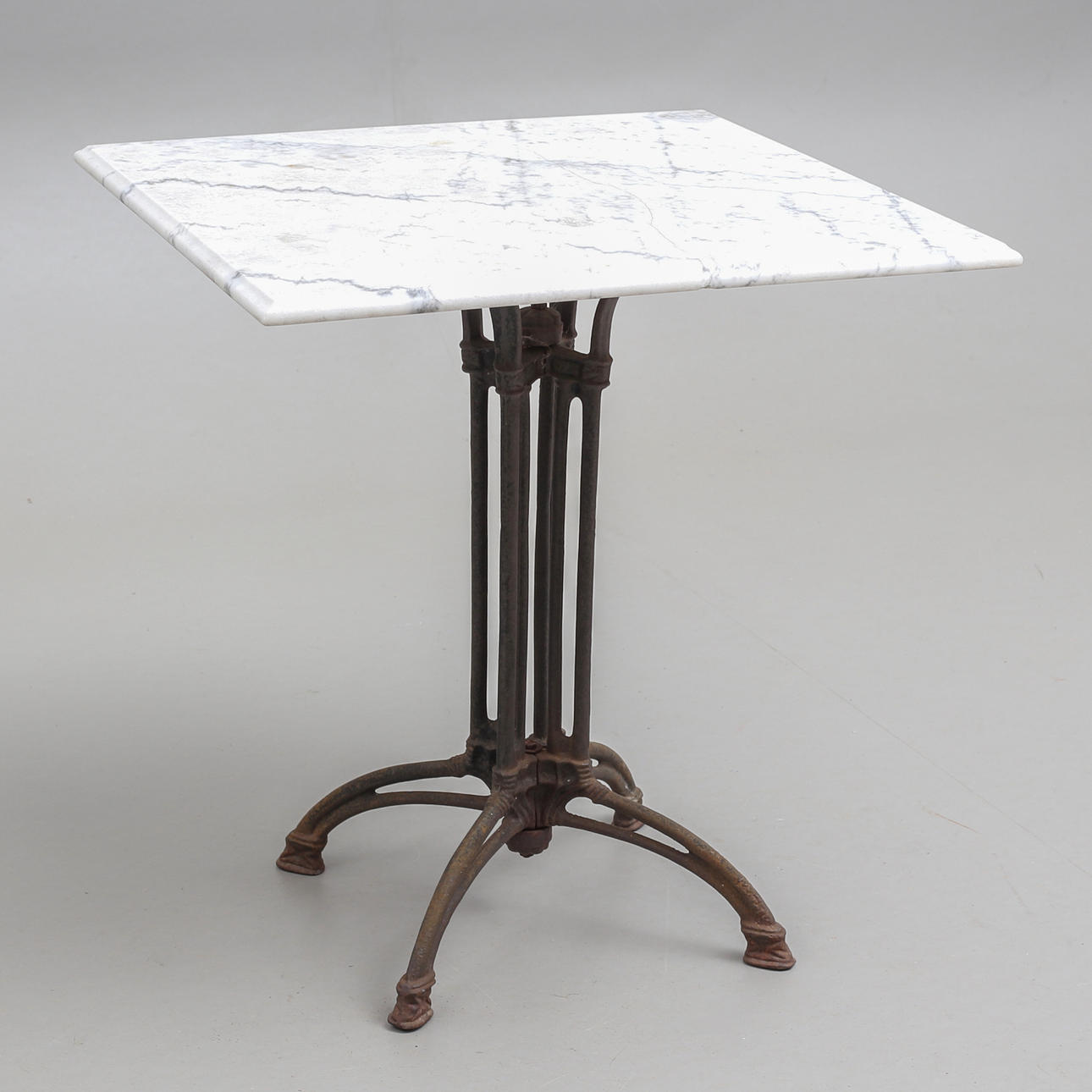 CAFE TABLE, cast iron base with marble top, 20th century.