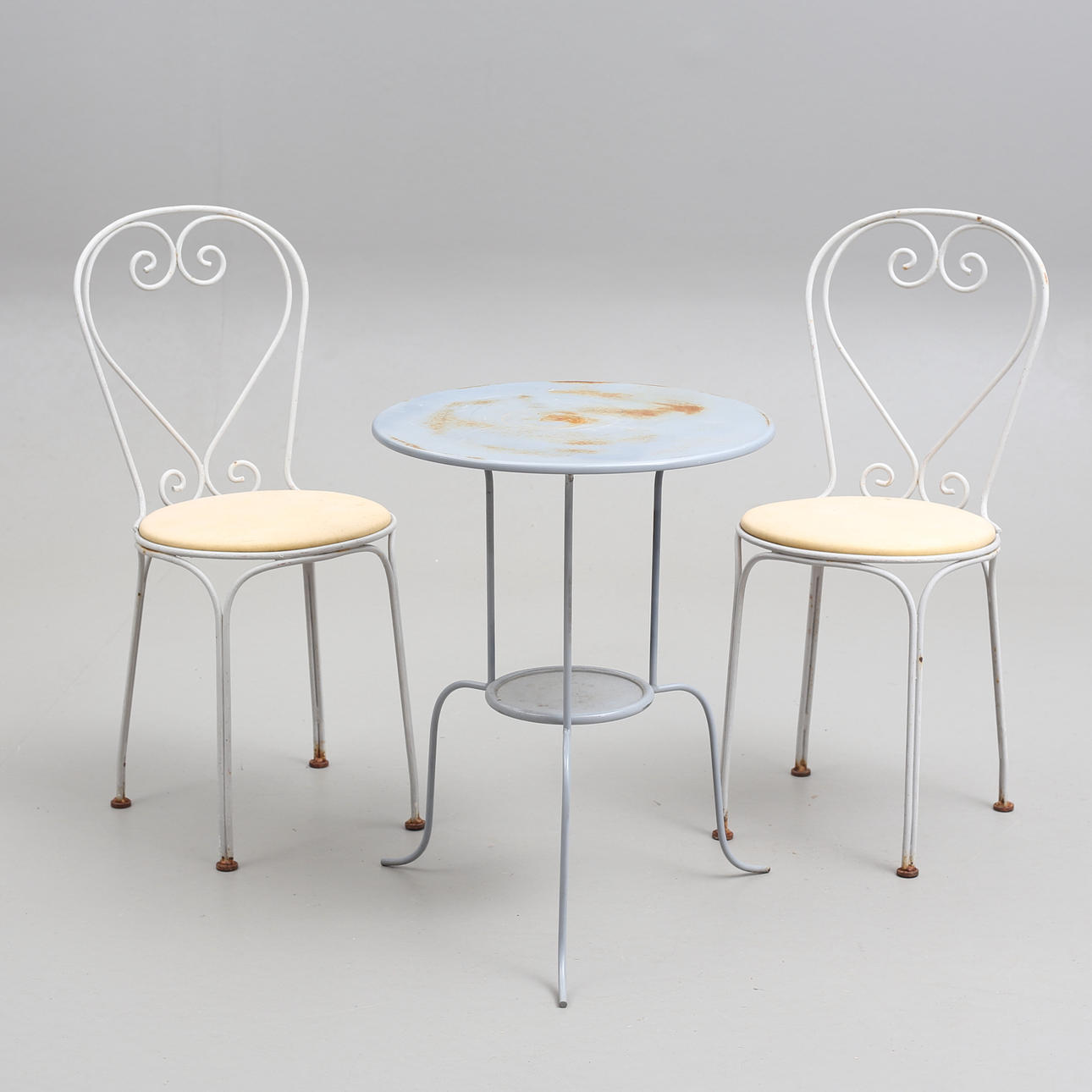 CAFÉ CHAIRS, a pair, iron, and TABLE, 20th century.