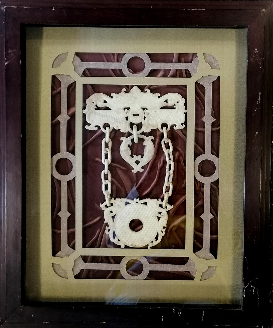 ORIENTAL STONE CARVING MOUNTED IN A LATER FRAME.
