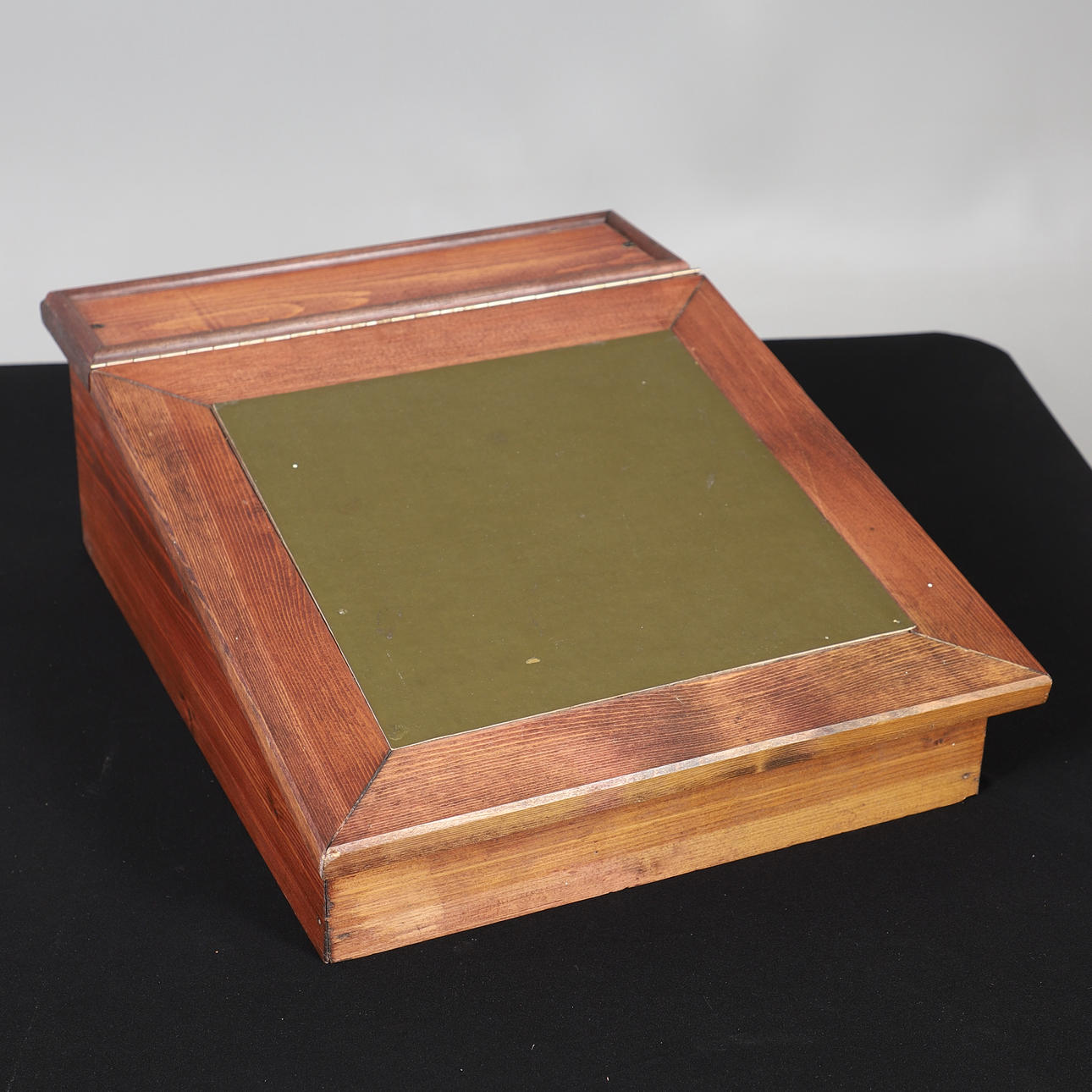 A STAINED PINE WRITING SLOPE.