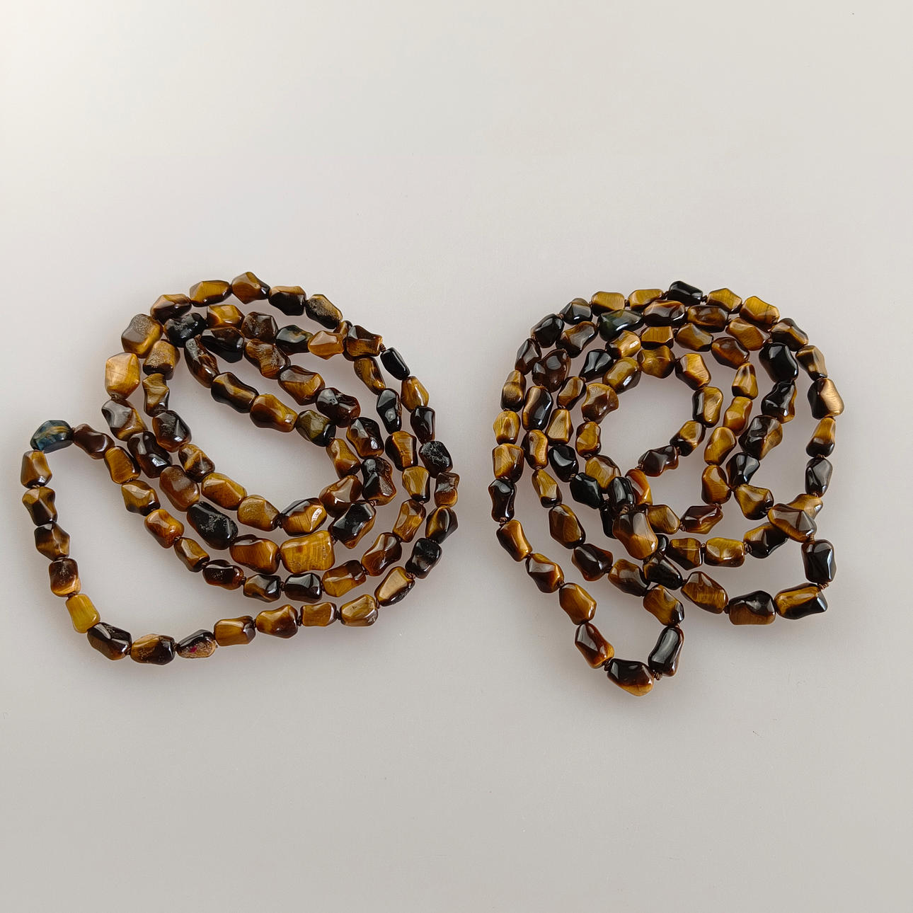 TWO TIGER'S EYE NECKLACES.