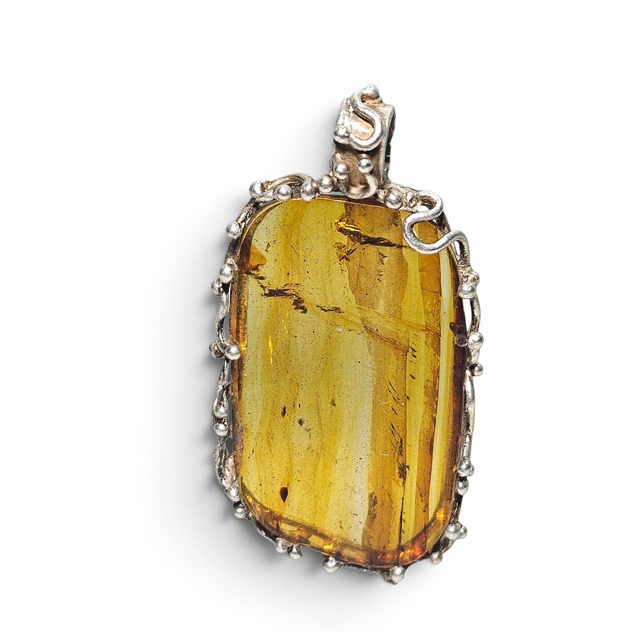 Amber pendant with sterling silver filigree setting.