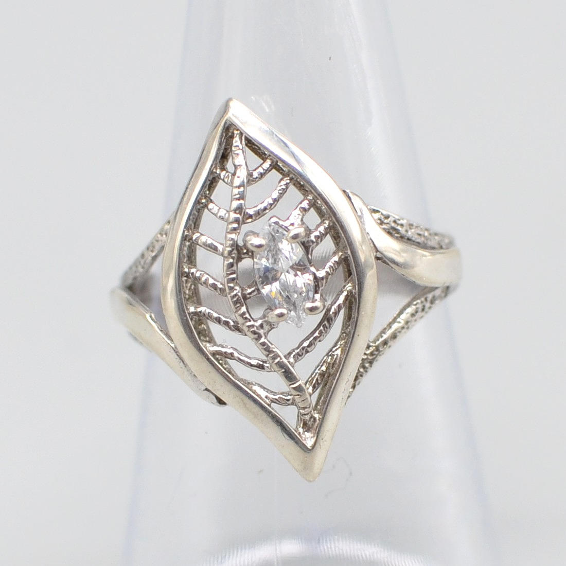 "J.B." DESIGNER RING, LEAF SHAPE, STERLING SILVER AND RHINESTONE, OPENWORK SETTING, MATTE AND POLISHED, 20TH CENTURY.