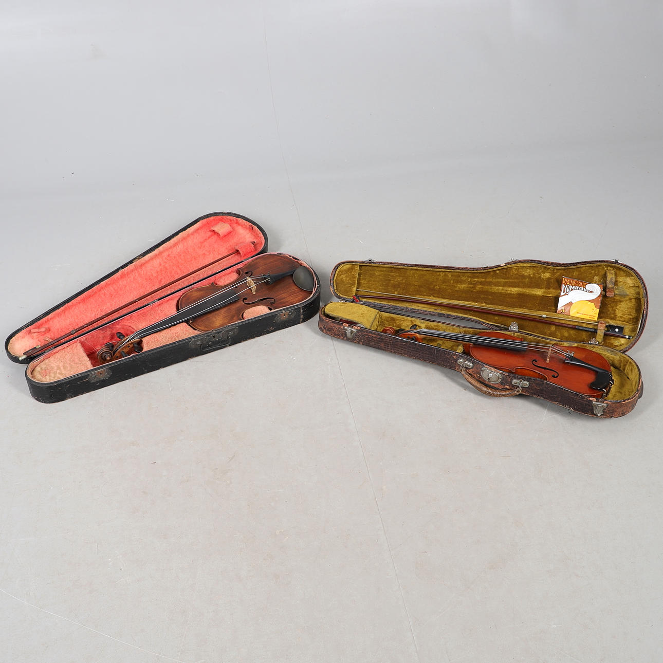 TWO CASED VIOLINS.