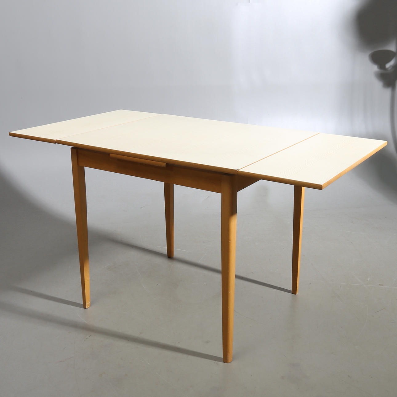 DINING TABLE, laminate top, mid-20th century.